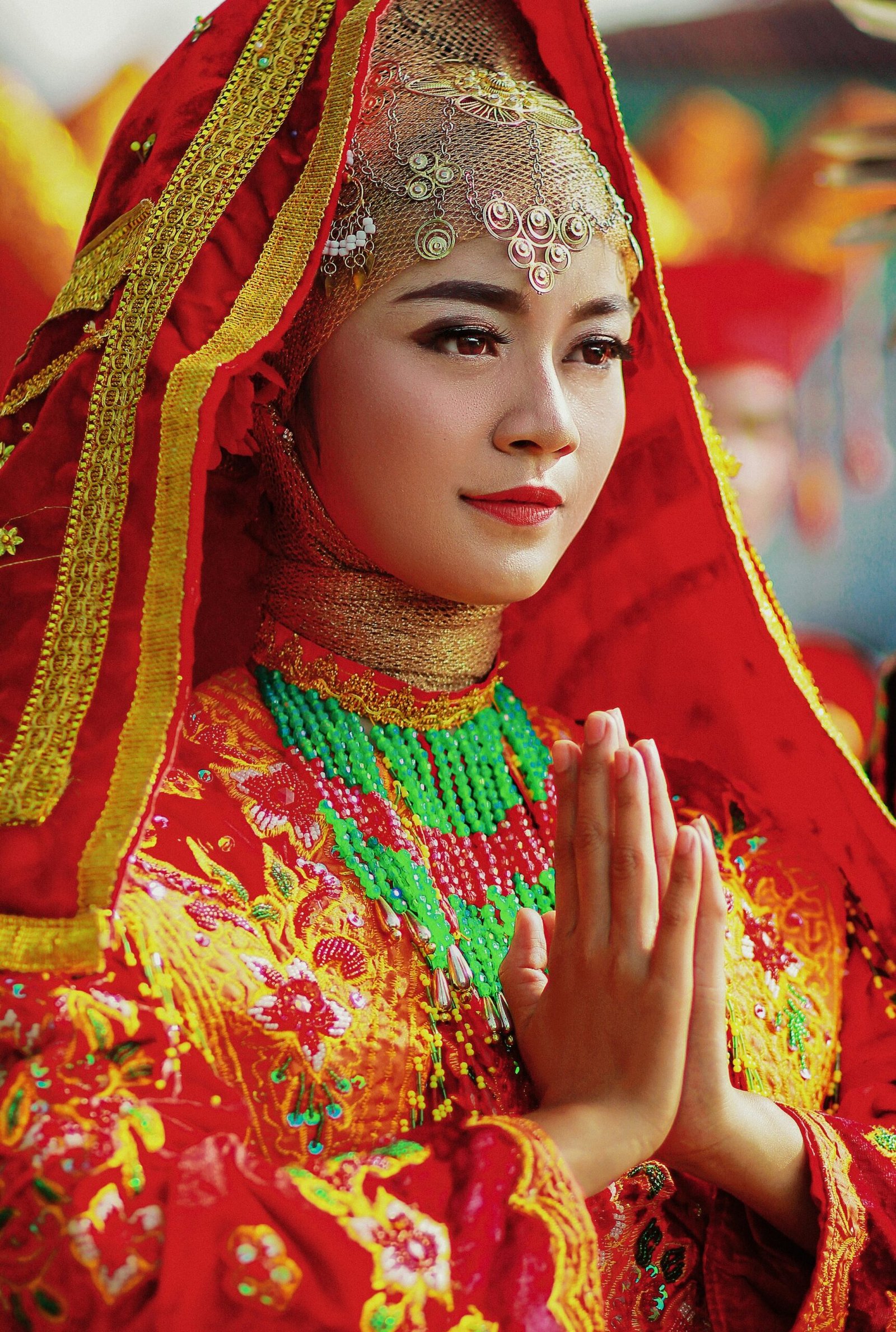 a woman wearing a red veil and a red headdress